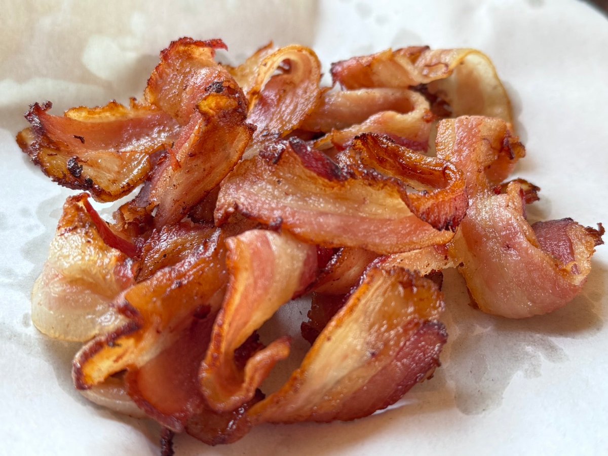 A plate of cooked, crispy honey garlic apple/cherry wood smoked bacon.