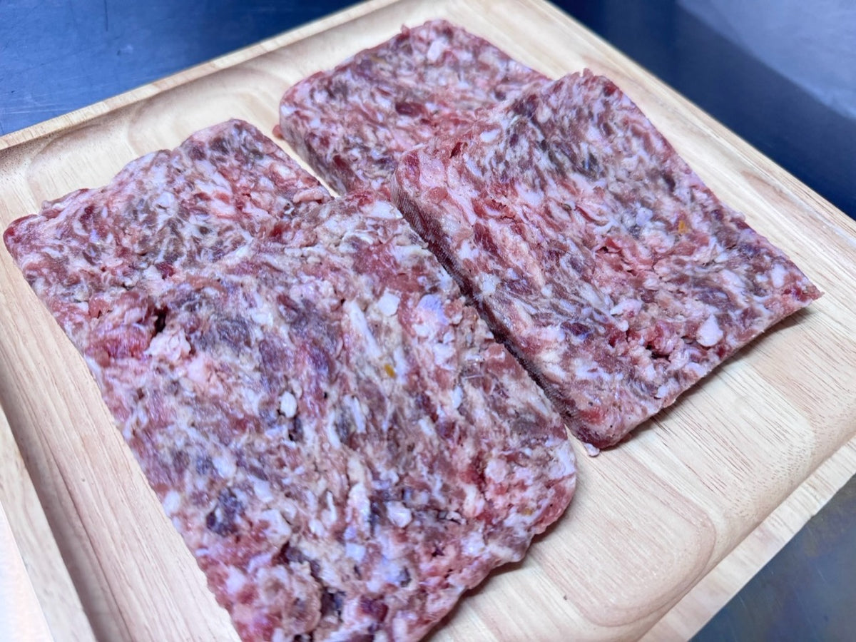 Handmade, hand-sliced Lorne sausages with Wagyu beef and free-range pork on a wooden board