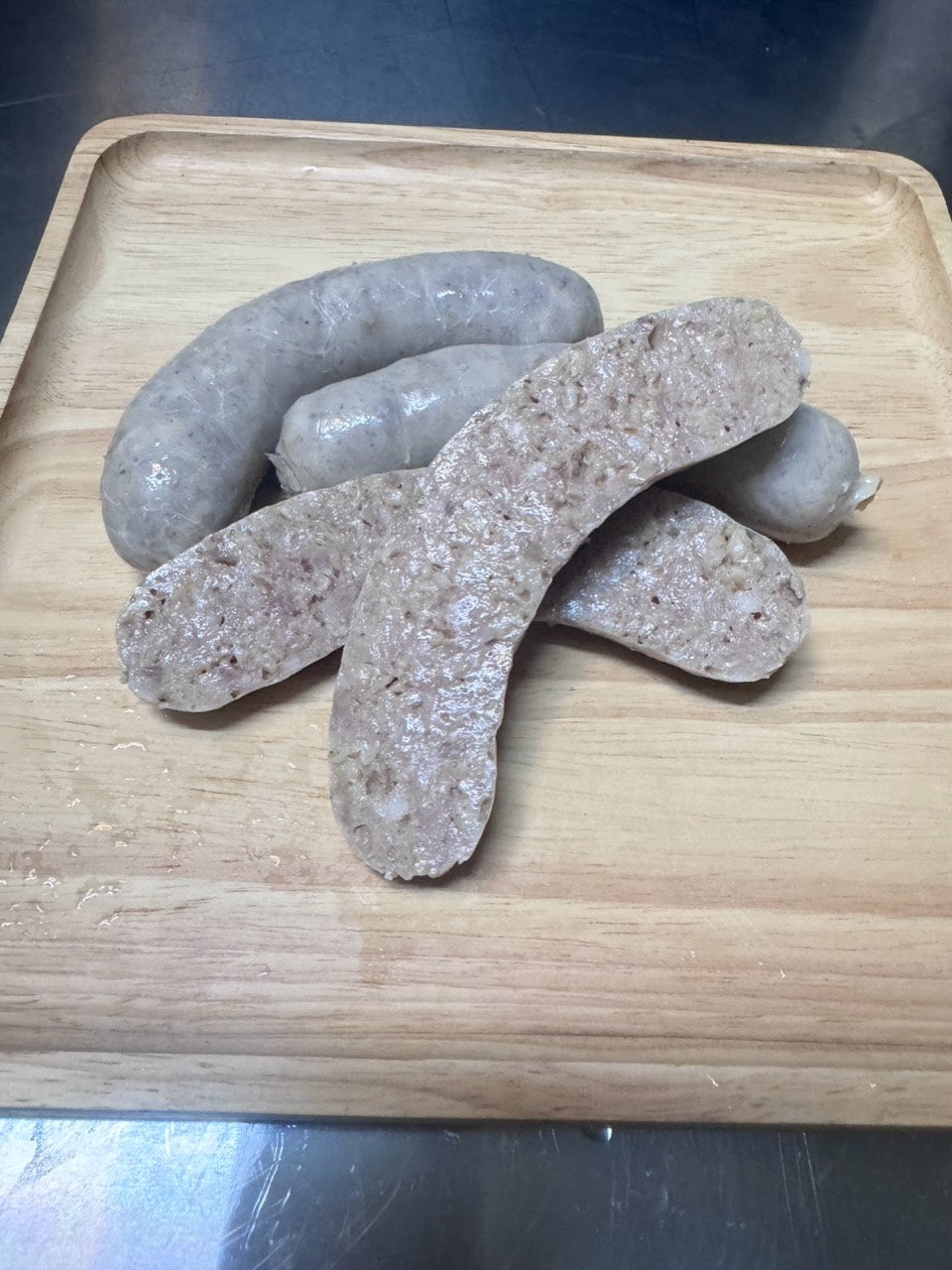 Chef’s Sausage white pudding links and sliced white pudding on a wooden board