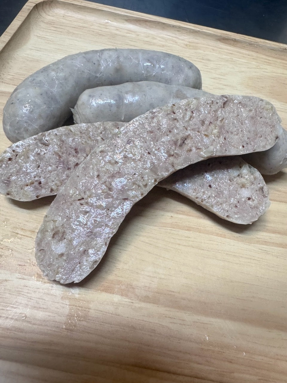 Close-up of Chef’s Sausage white pudding links and their sliced texture